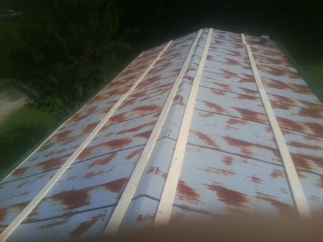 Rusted metal roof panels with new wood purlins before replacement — Storm Damage Roof Repair in Delafield by Roofing Brothers